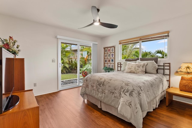 bedroom featuring hardwood / wood-style floors, ceiling fan, access to outside, and multiple windows