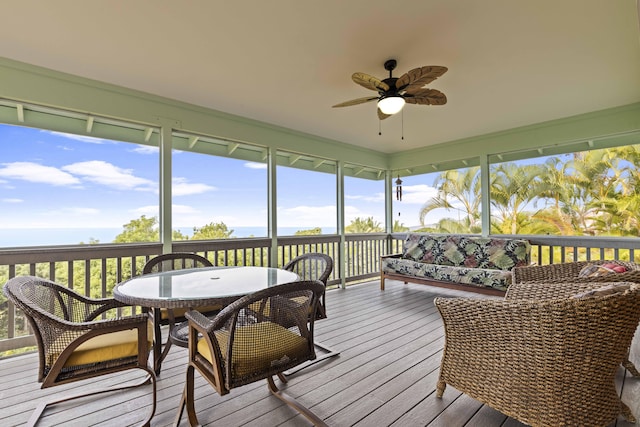 sunroom / solarium featuring ceiling fan