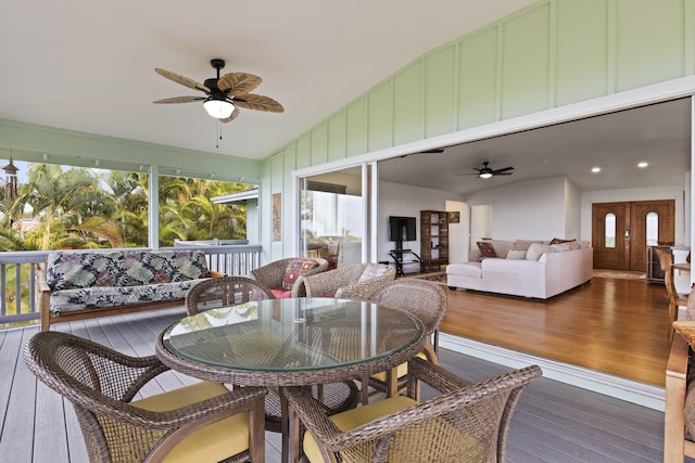 sunroom / solarium with ceiling fan and vaulted ceiling