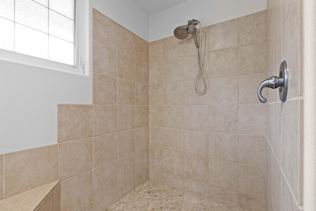 bathroom featuring tiled shower