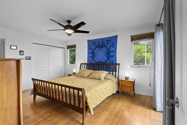 bedroom featuring ceiling fan, light wood-type flooring, and a closet