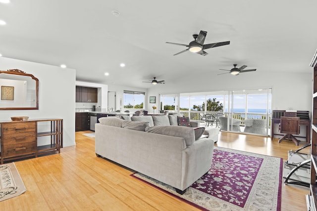 living room with lofted ceiling and light hardwood / wood-style flooring