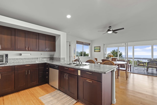 kitchen with sink, light hardwood / wood-style flooring, appliances with stainless steel finishes, kitchen peninsula, and light stone countertops