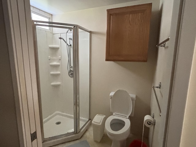 bathroom featuring toilet and an enclosed shower