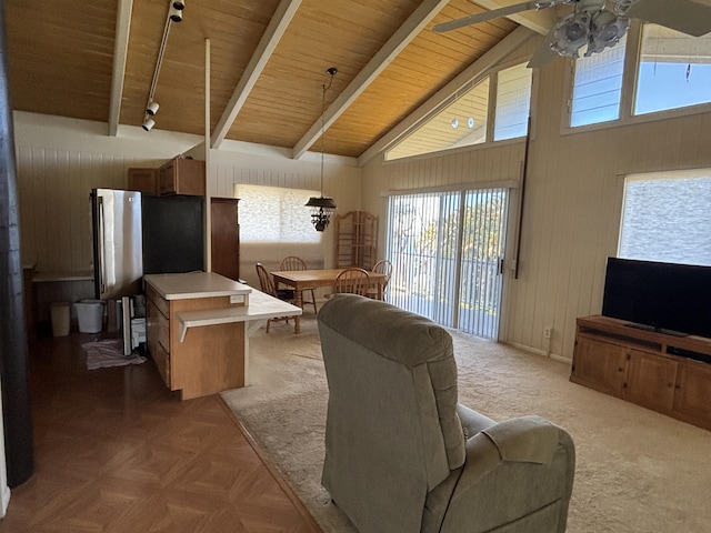 living room with parquet floors, wood ceiling, ceiling fan, beam ceiling, and high vaulted ceiling