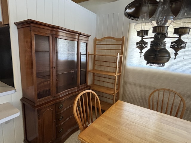 dining room featuring wooden walls