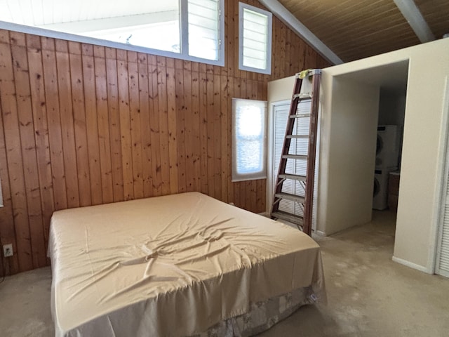 carpeted bedroom with wooden walls and lofted ceiling