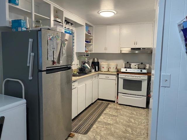 kitchen with white cabinets, stainless steel fridge, and white range with electric stovetop