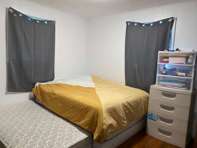 bedroom with dark wood-type flooring