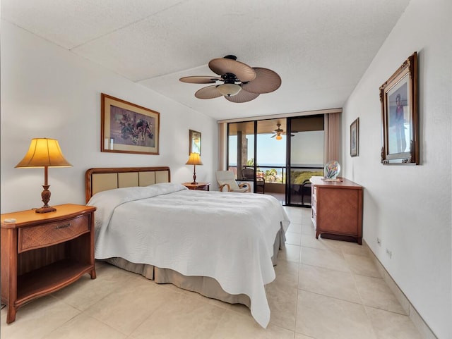 bedroom featuring ceiling fan, floor to ceiling windows, access to exterior, and a textured ceiling