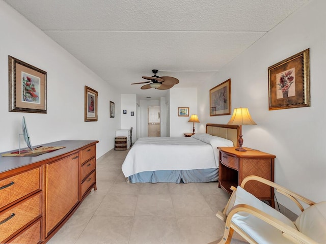 bedroom featuring ceiling fan and a textured ceiling