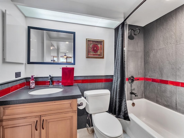 full bathroom with shower / bath combination with curtain, toilet, tile walls, and vanity