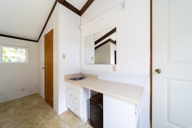 bathroom featuring vanity and vaulted ceiling