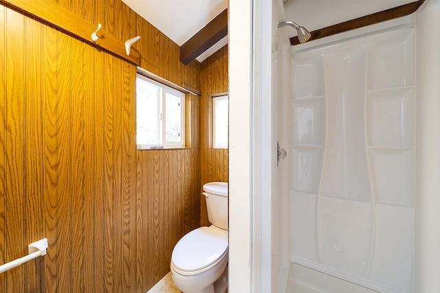 bathroom featuring beam ceiling, toilet, walk in shower, and wooden walls