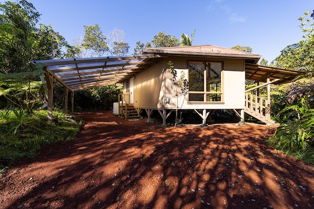 rear view of house featuring a carport