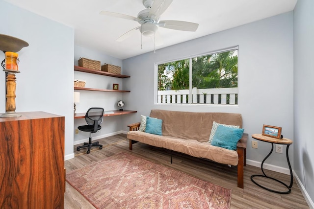 living area featuring ceiling fan and wood-type flooring