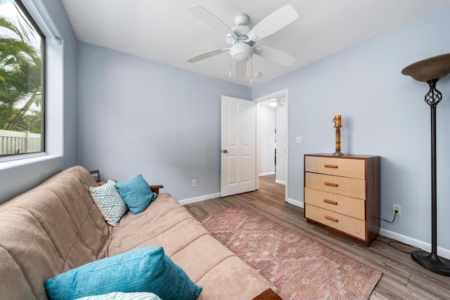 sitting room with dark hardwood / wood-style flooring and ceiling fan