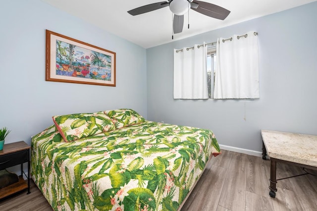 bedroom with ceiling fan and hardwood / wood-style floors