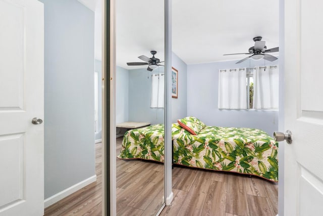 bedroom with ceiling fan and hardwood / wood-style flooring