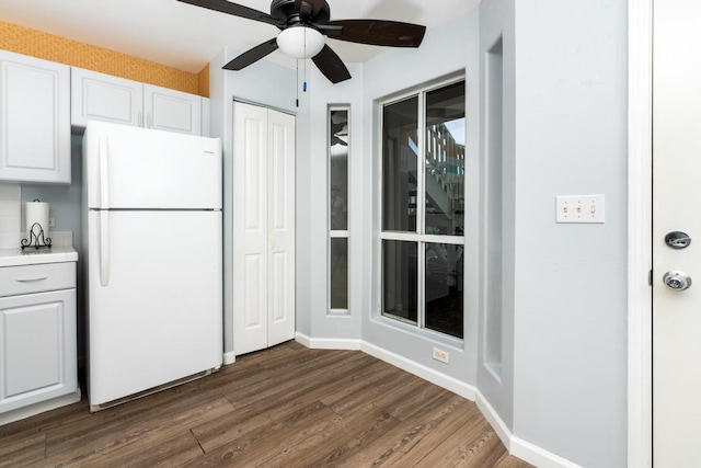 kitchen featuring white fridge, white cabinetry, ceiling fan, and dark wood-type flooring