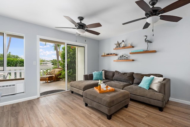 living room with ceiling fan and light wood-type flooring