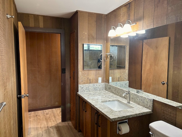 bathroom with vanity, hardwood / wood-style floors, and toilet