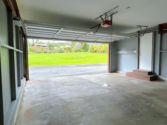 garage featuring a garage door opener and a yard