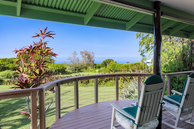 wooden terrace featuring a lawn