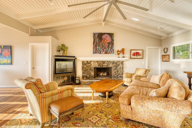 living room featuring ceiling fan, vaulted ceiling with beams, wood-type flooring, a fireplace, and wood ceiling