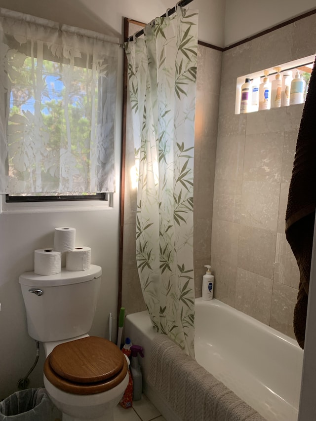 bathroom featuring shower / bath combination with curtain and toilet