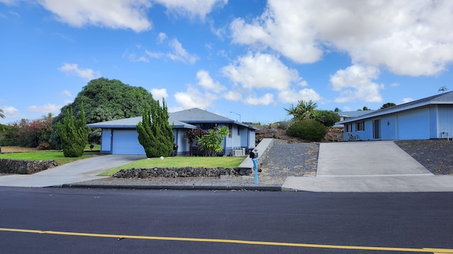 ranch-style house featuring a garage and a front lawn