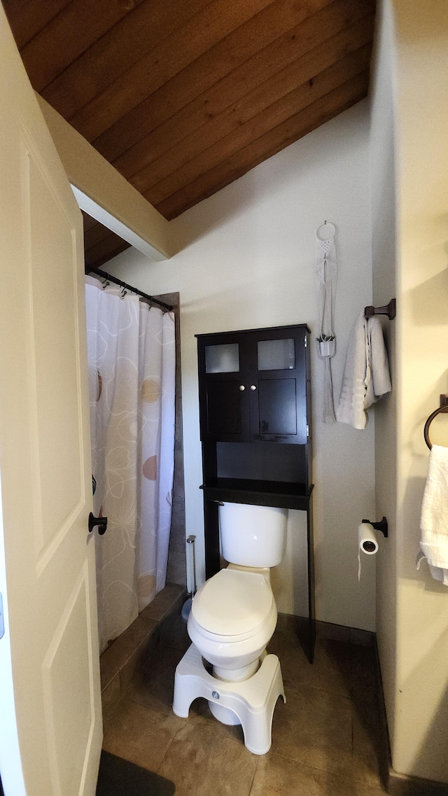 bathroom featuring tile patterned flooring, toilet, curtained shower, and wood ceiling