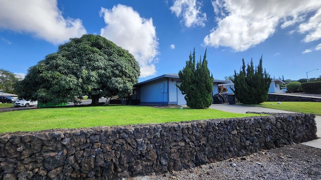 view of side of property with a yard