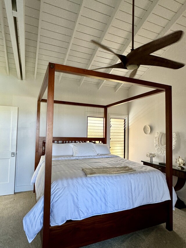 bedroom featuring carpet, lofted ceiling with beams, and ceiling fan