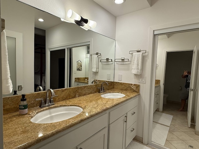 bathroom featuring tile patterned floors, vanity, and toilet