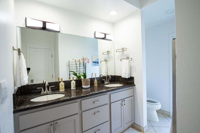 bathroom featuring tile patterned flooring, vanity, and toilet