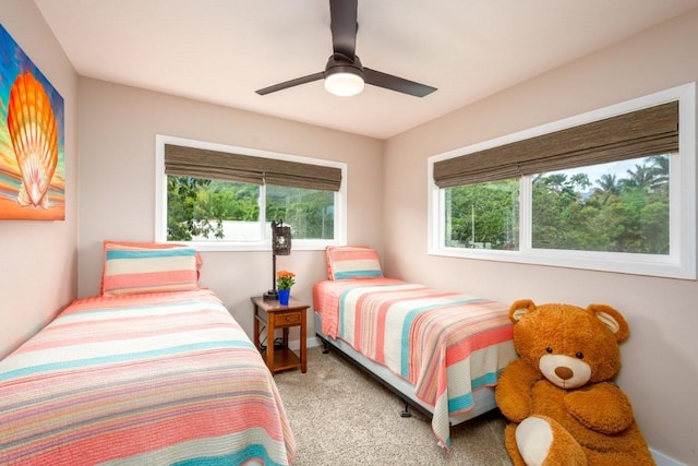 bedroom featuring ceiling fan and light carpet