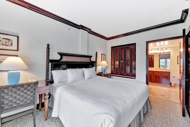 bedroom featuring ornamental molding and connected bathroom