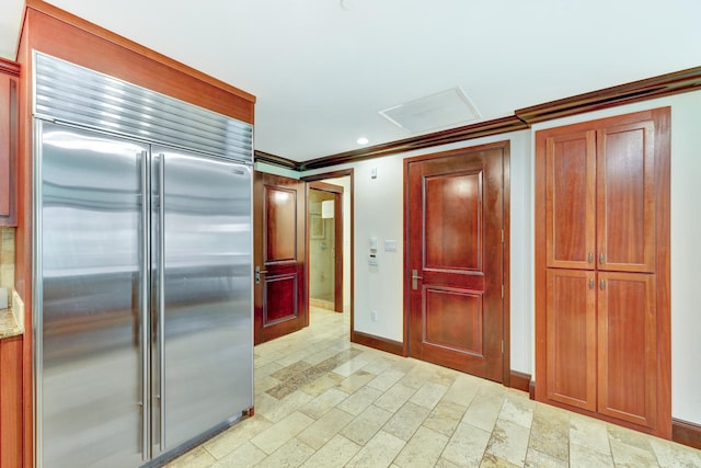 kitchen with ornamental molding and stainless steel built in fridge