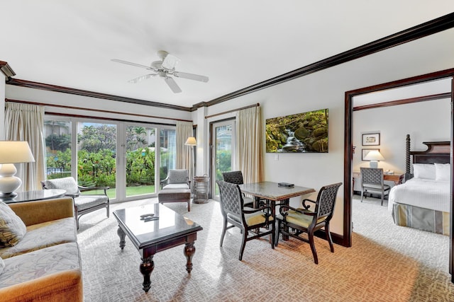 living room featuring ornamental molding, a healthy amount of sunlight, light carpet, and ceiling fan