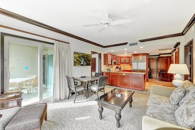 living room featuring ornamental molding and ceiling fan