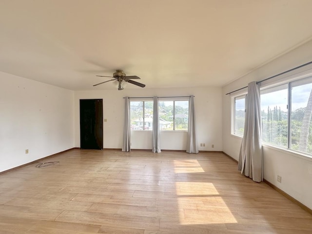 spare room with ceiling fan, light hardwood / wood-style floors, and plenty of natural light