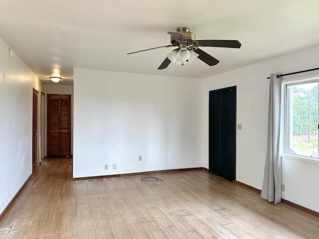 unfurnished room featuring ceiling fan and light wood-type flooring