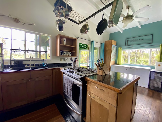 kitchen featuring ceiling fan, sink, dark wood-type flooring, beamed ceiling, and white gas range oven