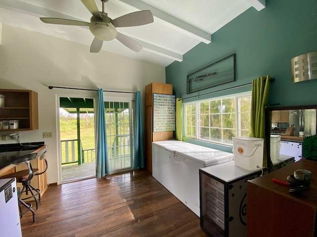 kitchen featuring dark hardwood / wood-style flooring, ceiling fan, plenty of natural light, and lofted ceiling with beams