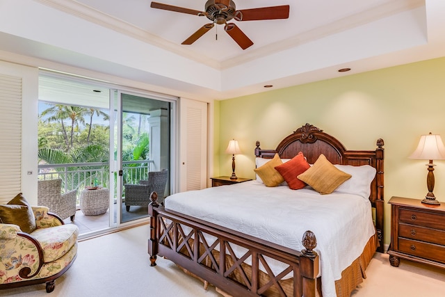 bedroom featuring ceiling fan, access to exterior, a tray ceiling, crown molding, and light carpet