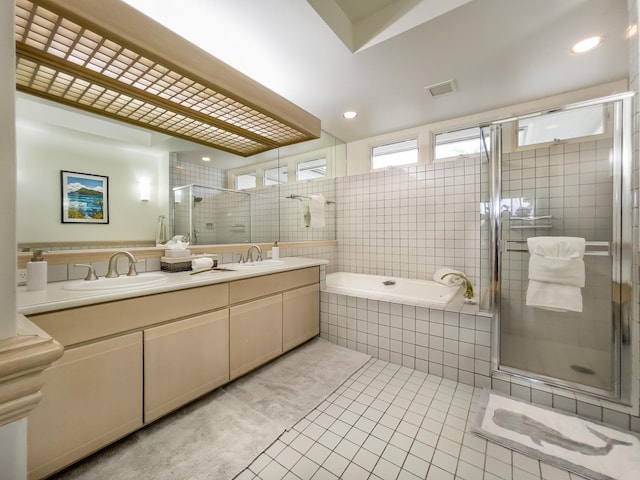 bathroom featuring tile patterned floors, vanity, and shower with separate bathtub