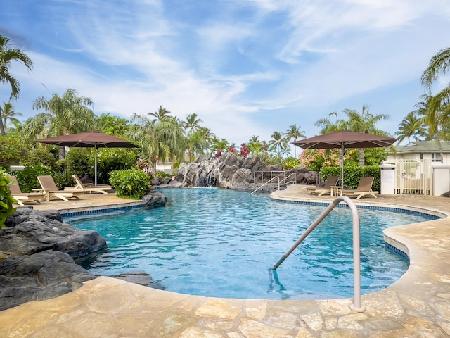 view of swimming pool featuring pool water feature and a patio