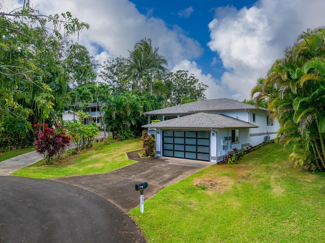 view of front of property with a garage and a front yard