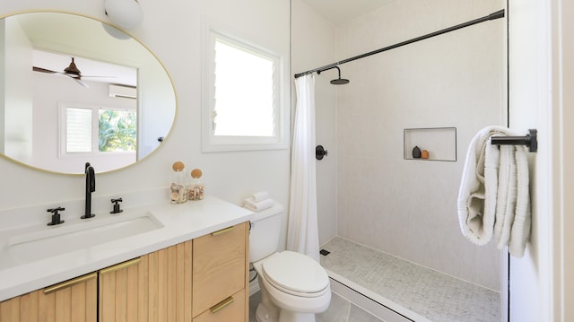 bathroom featuring a shower with curtain, toilet, ceiling fan, and vanity